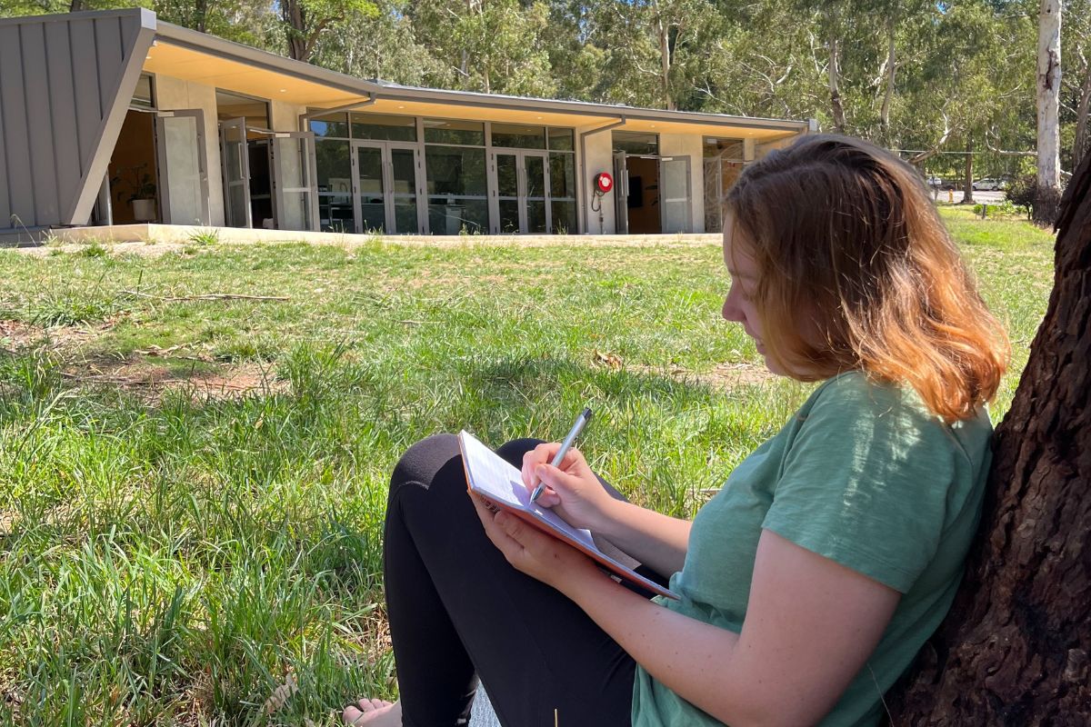 Senior students reflecting together outdoors at Woodhouse