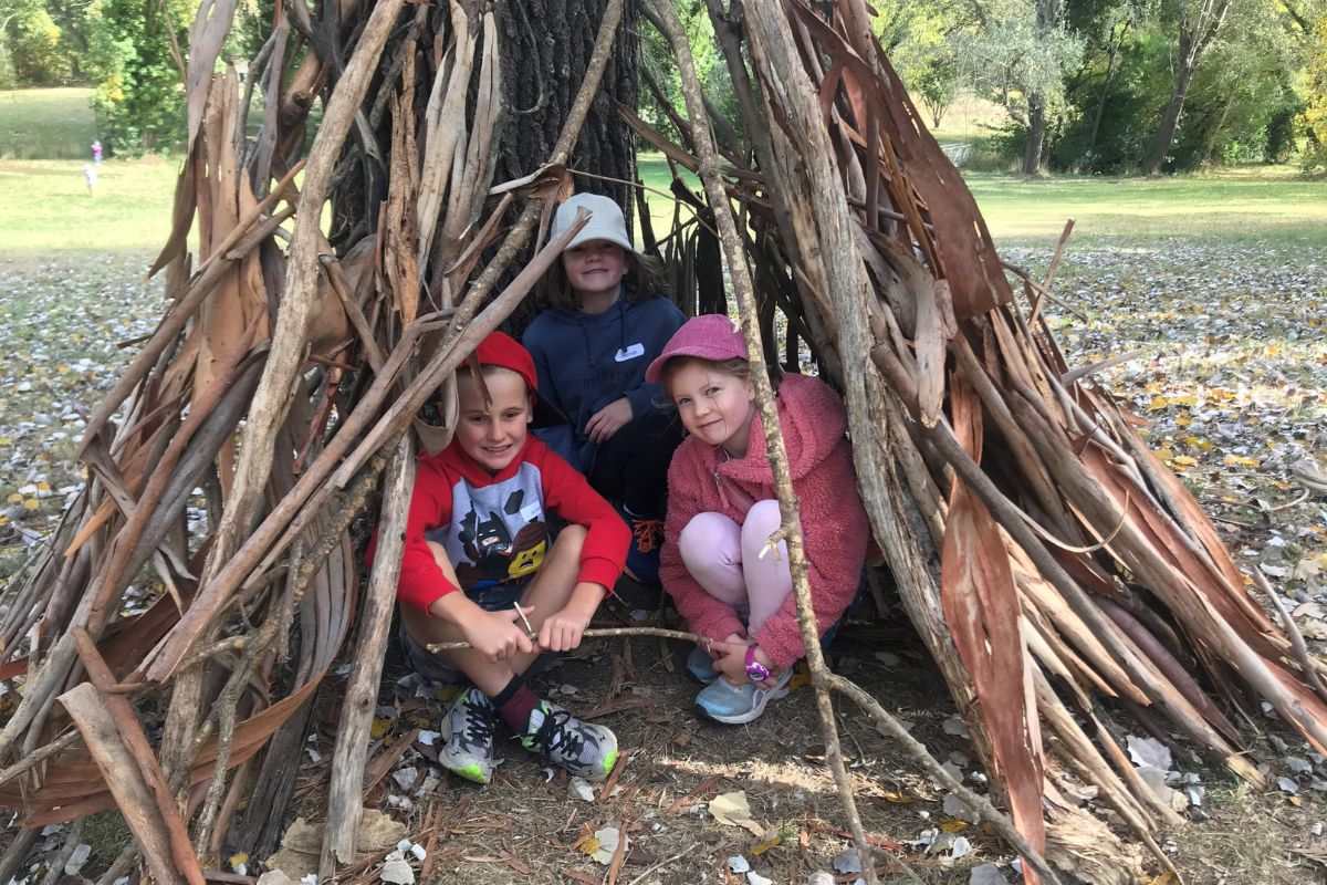 Children building a shelter during a Seedlings excursion at Woodhouse